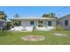 Backyard with green grass, garden beds, and a fence, perfect for outdoor enjoyment at 5000 18Th S Ave, Gulfport, FL 33707