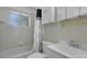 Cozy bathroom featuring a shower with a bathtub and white tile at 5000 18Th S Ave, Gulfport, FL 33707