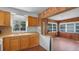 Kitchen featuring wood cabinetry, a double-basin sink, and an adjacent breakfast nook at 5000 18Th S Ave, Gulfport, FL 33707