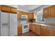 Updated kitchen with wooden cabinets, a white stove, and modern appliances for cooking enjoyment at 5000 18Th S Ave, Gulfport, FL 33707