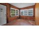 Cozy sunroom with wood paneled walls, tile floors, and ample natural light at 5000 18Th S Ave, Gulfport, FL 33707