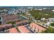 A scenic aerial view of townhome community near waterfront, showcasing pools, lush landscaping, and stunning ocean view at 5033 Blue Runner Ct, New Port Richey, FL 34652