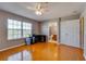 Bright bedroom with wood floors, a ceiling fan, desk, and adjacent bathroom, offering comfort and convenience at 5033 Blue Runner Ct, New Port Richey, FL 34652