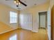 Bedroom featuring bamboo floors, a ceiling fan, and a double door closet at 5033 Blue Runner Ct, New Port Richey, FL 34652