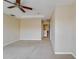 Spacious bedroom featuring plush carpet, neutral walls, and a ceiling fan at 5033 Blue Runner Ct, New Port Richey, FL 34652