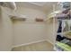 Walk-in closet features built in metal shelving, perfect for maximum organization and storage at 5033 Blue Runner Ct, New Port Richey, FL 34652