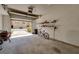 Open garage with brick driveway, shelving, and a bicycle inside at 5033 Blue Runner Ct, New Port Richey, FL 34652
