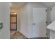 Hallway with decorative wrought iron security gate, tile flooring, and access to additional rooms at 5033 Blue Runner Ct, New Port Richey, FL 34652