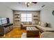 Living room with modern furniture, neutral-toned sectional, and mounted shelving at 5033 Blue Runner Ct, New Port Richey, FL 34652