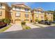 Charming townhomes showcase neutral stucco exteriors, private garages, and paved driveways under a clear blue sky at 5033 Blue Runner Ct, New Port Richey, FL 34652