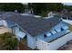 Aerial view showing the house with a fenced yard, and a well-maintained roof at 6800 William Tell Dr, New Port Richey, FL 34653