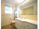 Bathroom featuring linoleum flooring, ample counter space, and a large mirror at 6800 William Tell Dr, New Port Richey, FL 34653