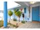 Inviting covered porch with tiled walkway and a well manicured garden at 6800 William Tell Dr, New Port Richey, FL 34653