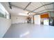 Spacious garage with painted floors, washer, dryer, and utility sink at 6800 William Tell Dr, New Port Richey, FL 34653