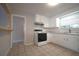 Functional kitchen showcasing bright cabinetry, tiled backsplash and new appliances at 6800 William Tell Dr, New Port Richey, FL 34653