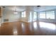 Bright living room featuring hardwood floors, fresh paint and abundant natural light at 6800 William Tell Dr, New Port Richey, FL 34653