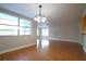 Light-filled living room with hardwood floors, natural light and decorative lighting at 6800 William Tell Dr, New Port Richey, FL 34653