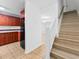 Bright entryway with staircase, tile flooring, and access to kitchen and living room at 7535 Abonado Rd, Tampa, FL 33615