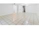 Open living area with tile flooring, white walls, and ample natural light at 7535 Abonado Rd, Tampa, FL 33615