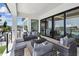 Spacious balcony with waterfront views, modern furniture, and access to the home through large sliding glass doors at 7974 1St S Ave, St Petersburg, FL 33707