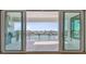 Outdoor patio area featuring sliding glass doors, an outdoor grill, and waterfront views at 7974 1St S Ave, St Petersburg, FL 33707