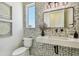Modern powder room with mosaic tile accent wall, designer mirror, and sleek fixtures at 7974 1St S Ave, St Petersburg, FL 33707