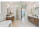 Elegant primary bath features dual vanities, soaking tub, and private water closet at 7974 1St S Ave, St Petersburg, FL 33707