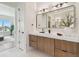 Bathroom showcasing a modern vanity with wood cabinets, white countertops, and stylish lighting at 7974 1St S Ave, St Petersburg, FL 33707