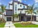 Modern home with a sleek design, black accents, and well-maintained landscaping at 7974 1St S Ave, St Petersburg, FL 33707