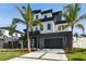 Modern two-story home boasts contemporary design, landscaping, and a multi-car garage at 7974 1St S Ave, St Petersburg, FL 33707
