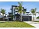 Modern two-story home boasts contemporary design, landscaping, and a multi-car garage at 7974 1St S Ave, St Petersburg, FL 33707