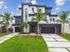 Modern home with black trim, multi-car garage, contemporary landscaping, and striking curb appeal at 7974 1St S Ave, St Petersburg, FL 33707