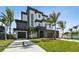 Modern two-story home with two-car garage, minimalist landscaping, and geometric design elements at 7974 1St S Ave, St Petersburg, FL 33707