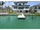 Waterfront modern home with a private dock, stunning architecture, and outdoor living spaces at 7974 1St S Ave, St Petersburg, FL 33707