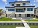 Elegant waterfront home featuring a private dock, stylish pool, and an elevated patio, perfect for enjoying waterfront living and entertaining at 7974 1St S Ave, St Petersburg, FL 33707