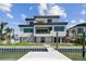 Stunning waterfront home showcasing a private dock and modern architectural design at 7974 1St S Ave, St Petersburg, FL 33707
