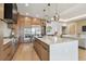 Expansive kitchen with stainless steel appliances, modern lighting, and a large island, open to the living area at 7974 1St S Ave, St Petersburg, FL 33707