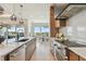 Gourmet kitchen with stainless steel appliances, a modern range hood, and a view of the dining area at 7974 1St S Ave, St Petersburg, FL 33707