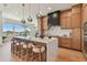 Elegant kitchen featuring a large island with seating, modern cabinetry, and stainless steel appliances at 7974 1St S Ave, St Petersburg, FL 33707