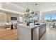 Modern kitchen featuring white marble counters, stainless steel appliances, and hardwood flooring at 7974 1St S Ave, St Petersburg, FL 33707
