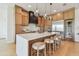 Modern kitchen with stainless appliances, island with seating, and wooden cabinets with bar lighting at 7974 1St S Ave, St Petersburg, FL 33707