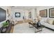 Bright living room featuring hardwood floors, a modern sofa, accent chairs, and stylish decor throughout at 7974 1St S Ave, St Petersburg, FL 33707