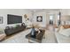 Bright living room featuring a modern media center, decorative rug, and stylish decor throughout at 7974 1St S Ave, St Petersburg, FL 33707