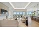 Expansive living room with waterfront views, featuring a fireplace and open layout to the kitchen at 7974 1St S Ave, St Petersburg, FL 33707