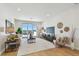 Bright living room featuring modern furniture, hardwood floors, a view of the outside, and stylish decor throughout at 7974 1St S Ave, St Petersburg, FL 33707