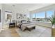 Bright main bedroom features water view, light wood floors, and neutral color palette at 7974 1St S Ave, St Petersburg, FL 33707