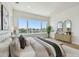 Bright main bedroom features water view, light wood floors, and elegant decor at 7974 1St S Ave, St Petersburg, FL 33707