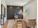 Home office featuring a modern glass desk, herringbone accent wall, and neutral seating at 7974 1St S Ave, St Petersburg, FL 33707