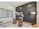 Home office with glass desk, neutral seating, statement wall and bright lighting at 7974 1St S Ave, St Petersburg, FL 33707