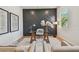 Bright office with a custom paneled wall, glass desk, and comfortable seating offers a modern workspace at 7974 1St S Ave, St Petersburg, FL 33707